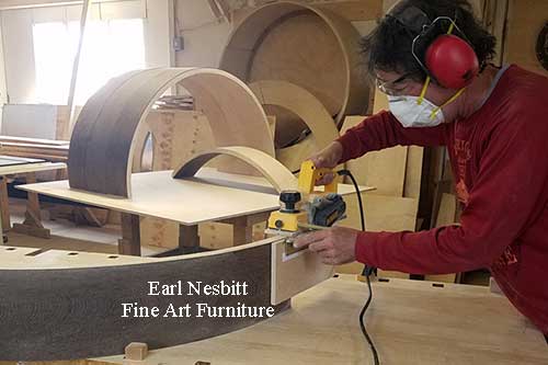 Earl hand fitting joinery of upper portion of custom made cabinet